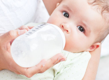 An infant bottle feeding