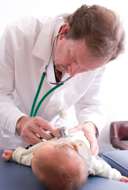 A doctor examining an infant